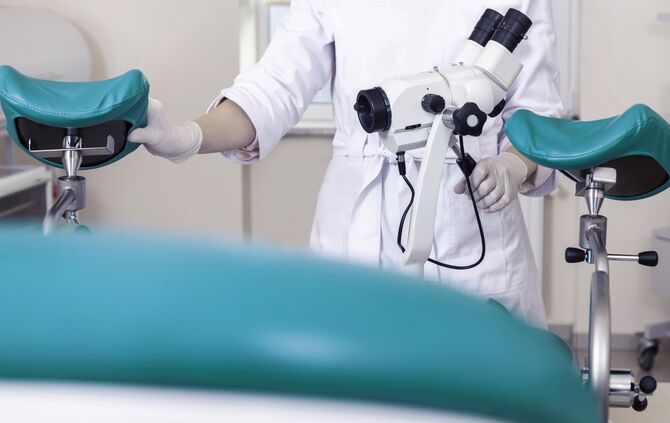 Gynecological room gynecologist chair equipment doctor female hands lens microscope optics