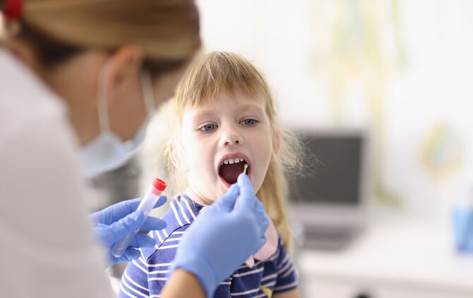 Doctor takes biological material from mouth with cotton swab