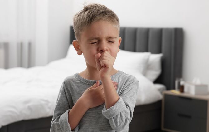 Sick boy coughing at home. Cold symptoms