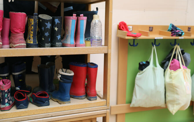 Kita Kindergarten beutel schuhe gummistiefel schuhregal symbol symbolbild symbolfoto