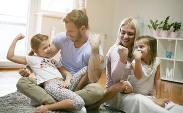 Family playing on floor.