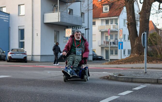 Theo Chatziavramidis überquert die Devizesstraße aus einer nahegelegenen Einmündung, damit er so wenig Bordsteine wie möglich pa