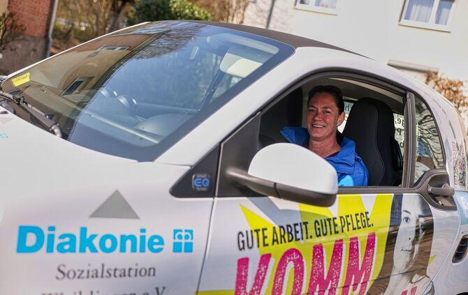 Isabel Löhr in dem Auto, mit dem sie für die Diakonie und Sozialstation Waiblingen im Einsatz ist.