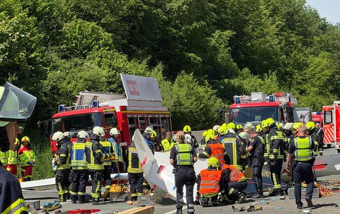 Rettungsdienste und Polizei arbeiten an der Unfallstelle, nachdem ein Segelflugzeug auf die A45 gestürzt ist.