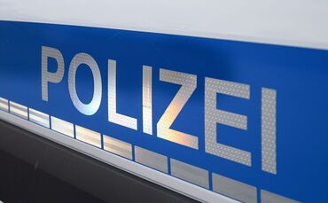 Der Polizei-Schriftzug auf einem Einsatzwagen.