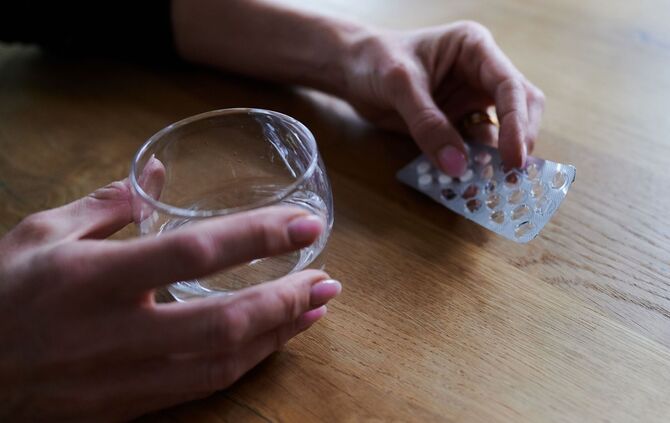 Frau hält Tabletten in der Hand