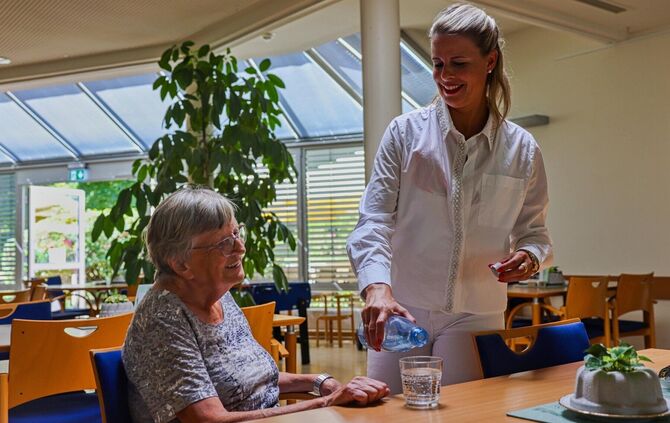 Viel trinken hat oberste Priorität: Hauptgeschäftsführerin Ulrike Brenner mit Bewohnerin Edeltraud Semet.